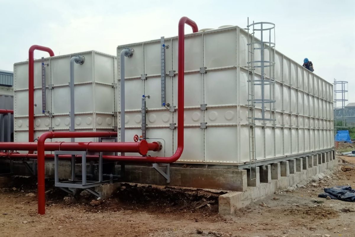 FRP tanks attached to red water pipes