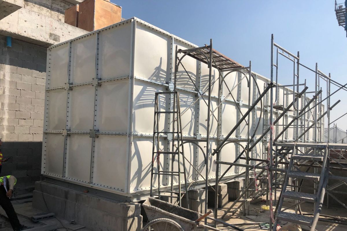 An FRP tnak being installed outdoors